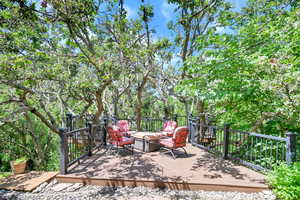 Deck featuring an outdoor living space with a fire pit