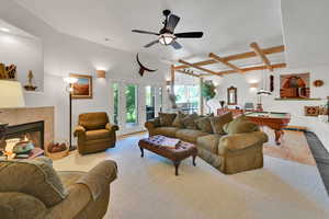 Living area featuring pool table, a tiled fireplace, a ceiling fan, and french doors