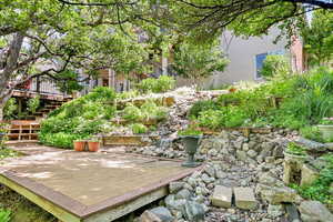 View of yard featuring a deck and stairs