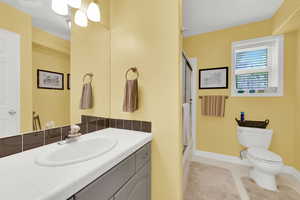 Full bathroom featuring a stall shower, vanity, and light tile patterned flooring