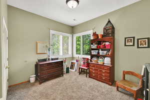 Sitting room with light colored carpet and baseboards
