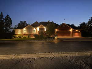 View of front of home featuring an attached garage, driveway, and board and batten siding