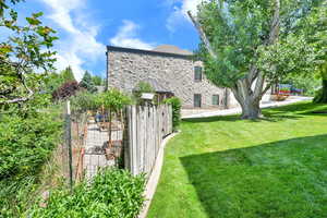 Rear view of house with stone siding