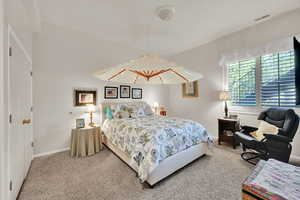 Bedroom featuring carpet floors and baseboards
