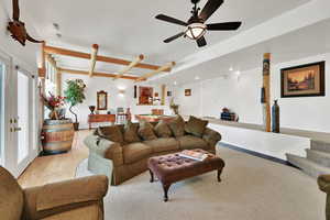Living room featuring wood-type flooring and a ceiling fan