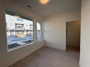 Unfurnished room with light wood-style flooring and baseboards