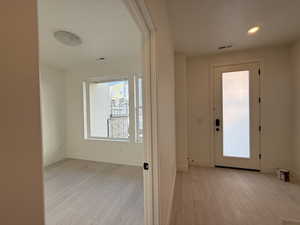 Entryway featuring light wood-style floors and recessed lighting