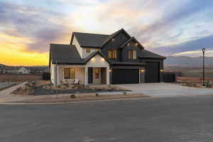 Modern farmhouse featuring a porch, board and batten siding, driveway, and a garage