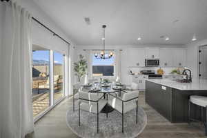 Dining area with hanging lights and dark wood-style floors