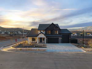 Modern farmhouse featuring a mountain view, a residential view, covered porch, driveway, and board and batten siding