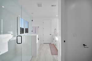 Full bathroom featuring vanity, a shower stall, a bath, and recessed lighting