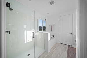 Bathroom featuring a stall shower and a garden tub