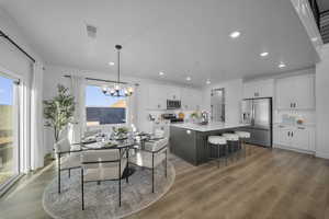 Dining room featuring suspended lighting and light wood finished floors