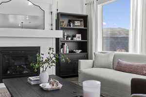 Living area with a glass covered fireplace and wood finished floors