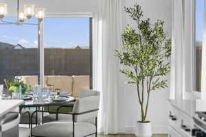 Dining space featuring suspended lighting and plenty of natural light