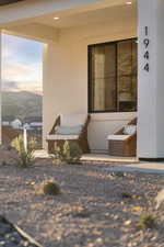 Doorway to property featuring a mountain view and stucco siding