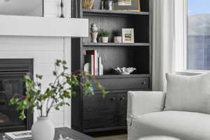 Sitting room featuring a glass covered fireplace