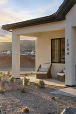 View of exterior entry featuring stucco siding and a mountain view