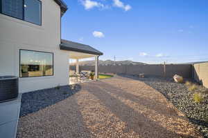Fenced backyard with a patio and a mountain view