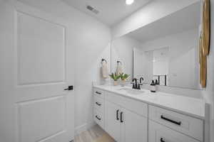Bathroom with vanity and baseboards