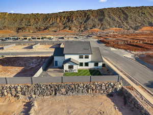 Aerial view of property and surrounding area with a mountainous background