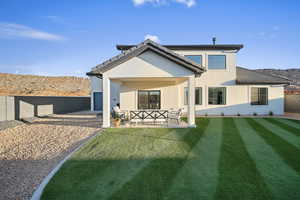 Rear view of house featuring a mountain view, a patio area, stucco siding, a fenced backyard, and a tile roof