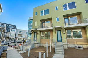 Contemporary house featuring stucco siding and a balcony