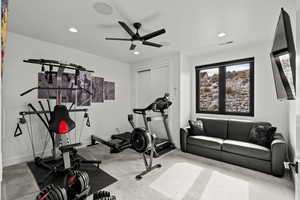 Exercise room featuring light carpet, recessed lighting, and ceiling fan