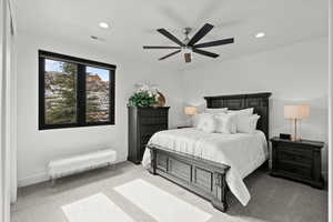 Bedroom with a ceiling fan, light carpet, and recessed lighting