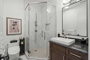 Bathroom featuring vanity and a stall shower