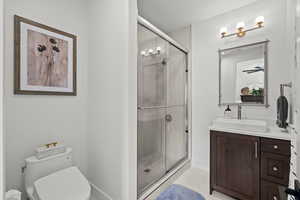 Bathroom featuring a shower stall, vanity, and light tile patterned floors