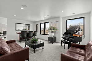 Upper level family Living room featuring light colored carpet and recessed lighting