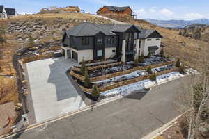 View of front of house featuring a mountain view, driveway, and a garage