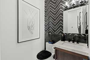 Bathroom with vanity and tile walls