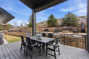 Deck with outdoor dining area and a grill