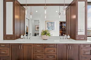 Primary bathroom with double vanity and recessed lighting