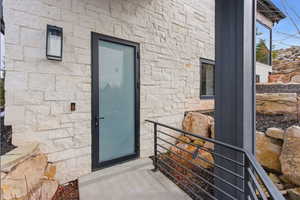 Entrance to ADU featuring stone siding