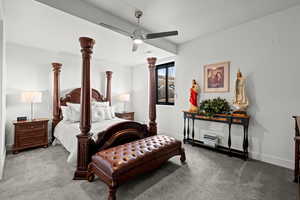 Carpeted bedroom with baseboards and a ceiling fan