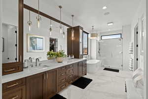 Primary Bathroom with double vanity, a shower stall, a soaking tub, light marble finish floors, and recessed lighting