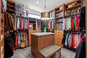 Walk in closet with light carpet