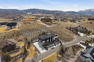 Aerial overview of property's location featuring nearby suburban area and mountains