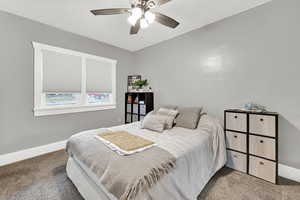 Bedroom featuring ceiling fan and carpet floors