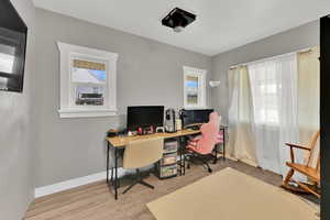 Office area with light wood-style floors and baseboards