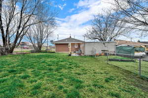 Rear view of property with a patio, a fenced backyard, and brick siding