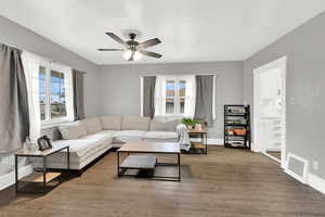 Living area featuring wood finished floors and a ceiling fan