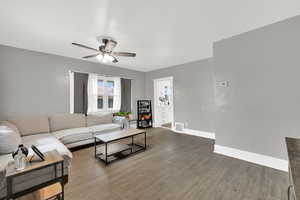 Living area with a ceiling fan and wood finished floors
