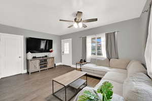 Living room featuring wood finished floors and ceiling fan