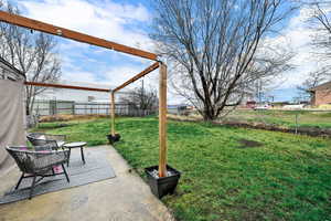 Fenced backyard with a patio
