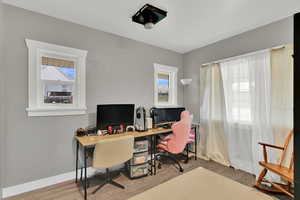 Office space featuring light wood finished floors and baseboards