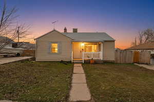 Bungalow-style house featuring covered porch and a chimney